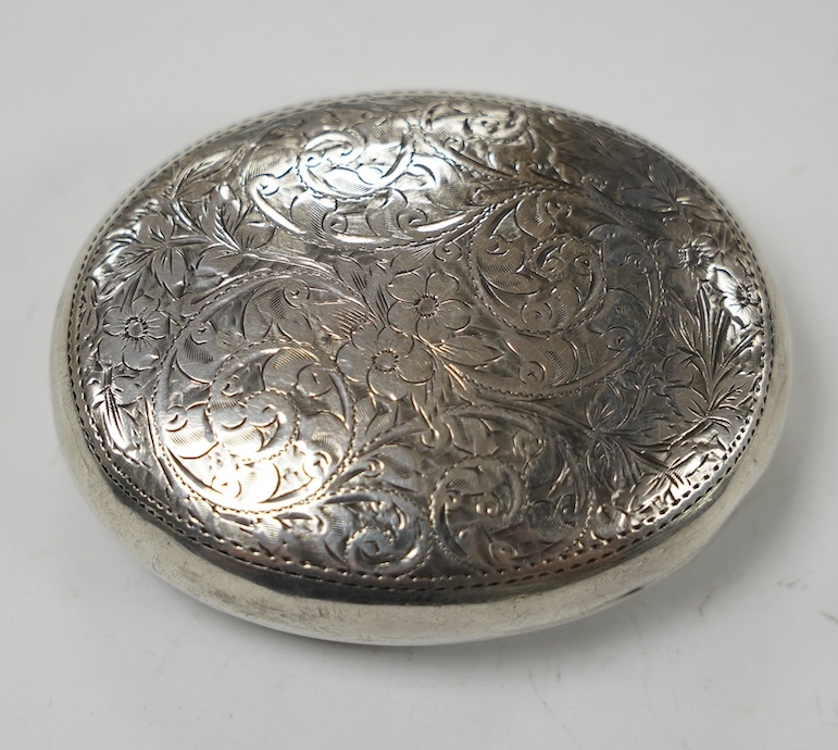 An Edwardian engraved silver oval tobacco box, Hilliard & Thomason, Birmingham, 1901, 75mm. Condition - poor to fair